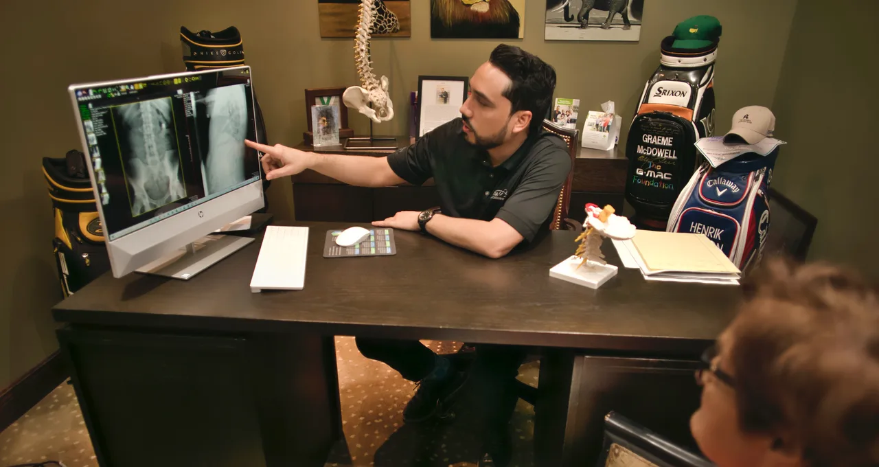 Chiropractor reviewing spinal X-rays with a patient in Orlando