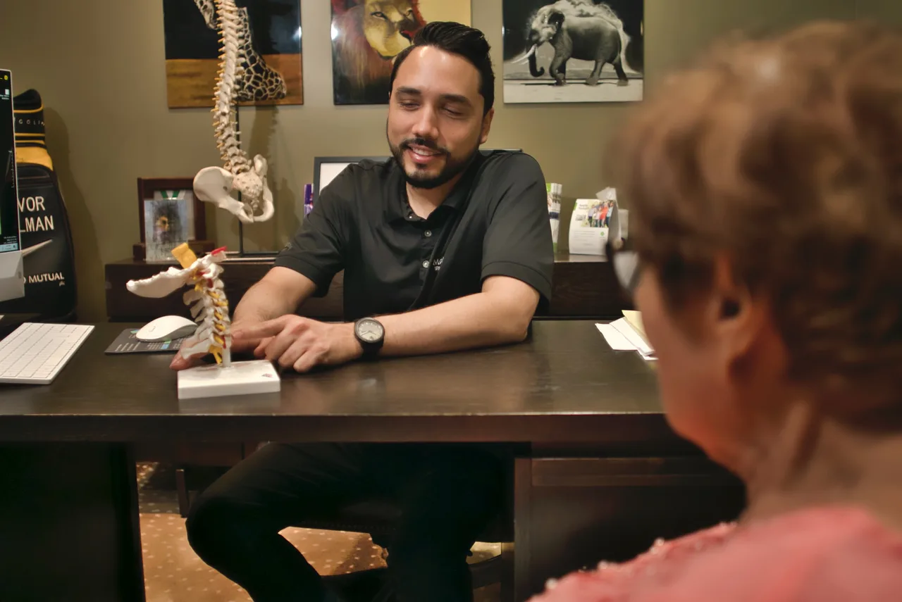 Orlando chiropractor consulting with a patient about pain relief
