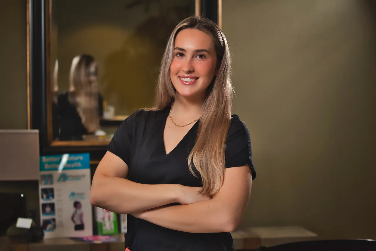 Smiling team member at Mattia Spinal Care & Rehab Center